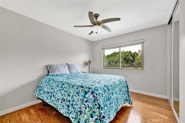 3595 Sego St, Irvine, CA 92606 - bedroom with baseboards, wood finished floors, and a ceiling fan