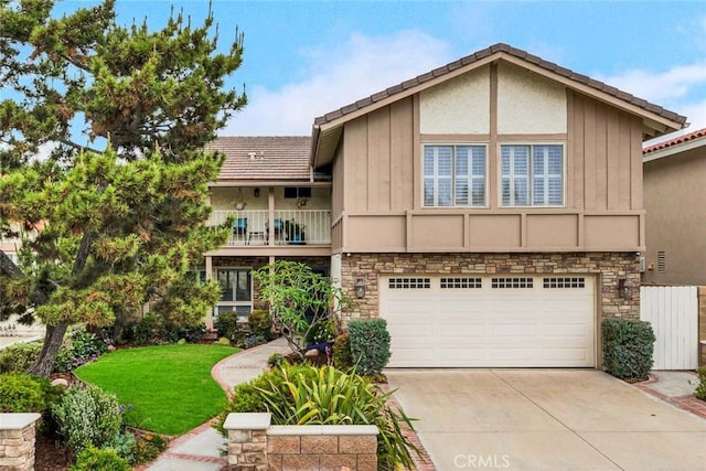 3595 Sego St, Irvine, CA 92606 - view of front of property featuring driveway, an attached garage, stone siding, a front yard, and a balcony