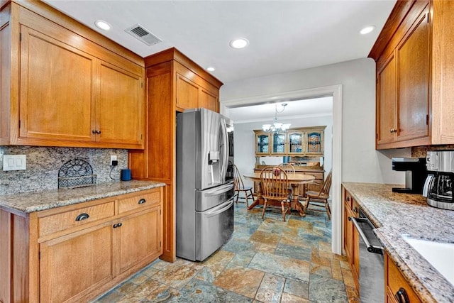 3595 Sego St, Irvine, CA 92606 - kitchen featuring stainless steel appliances, a chandelier, brown cabinets, light stone finish floors, and recessed lighting