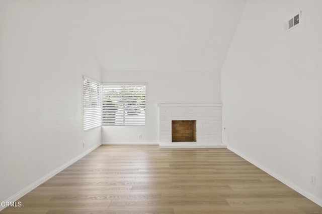 196 Mariposa Dr, Camarillo, CA 93012 - unfurnished living room featuring lofted ceiling, light wood-type flooring, a fireplace, and baseboards