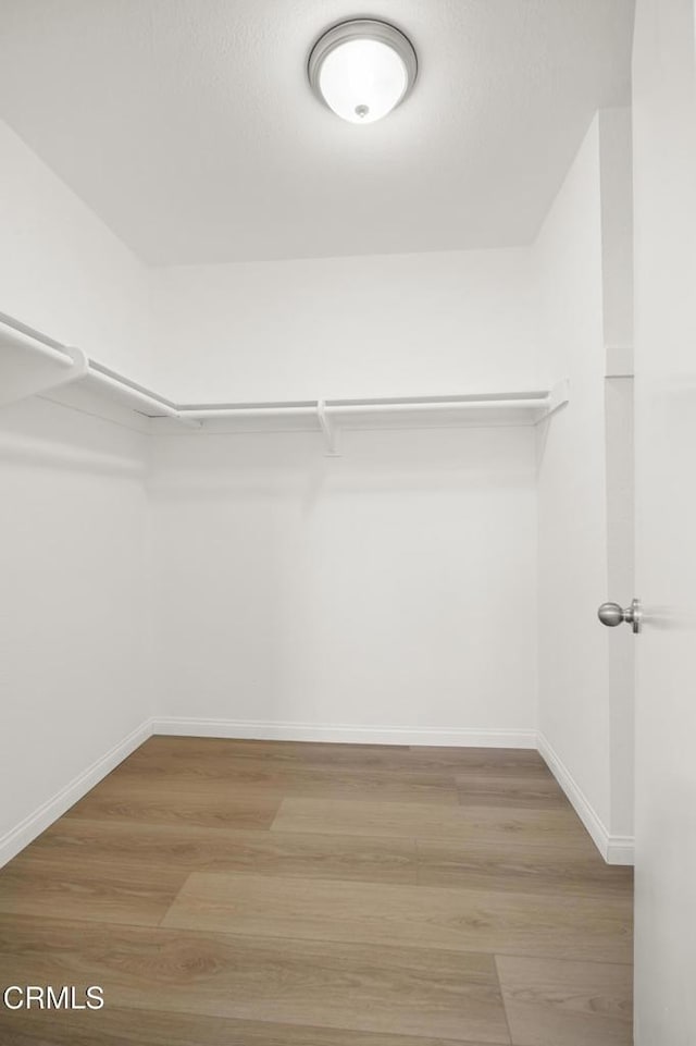 196 Mariposa Dr, Camarillo, CA 93012 - walk in closet featuring wood finished floors