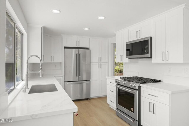 196 Mariposa Dr, Camarillo, CA 93012 - kitchen featuring appliances with stainless steel finishes, a sink, healthy amount of natural light, white cabinets, and recessed lighting