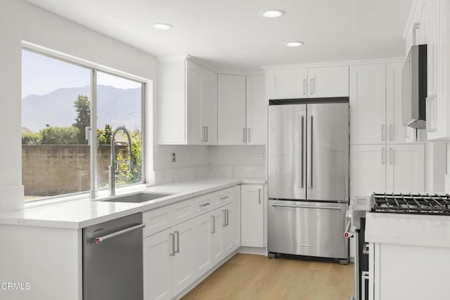 196 Mariposa Dr, Camarillo, CA 93012 - kitchen with appliances with stainless steel finishes, a sink, a mountain view, light countertops, and healthy amount of natural light