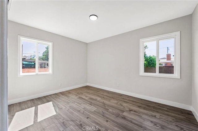 1715 E Redwood Ave, Anaheim, CA 92805 - unfurnished room with healthy amount of natural light, baseboards, and wood finished floors