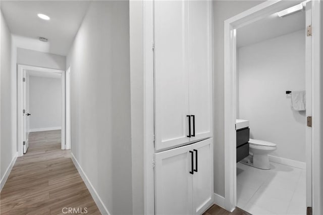 1715 E Redwood Ave, Anaheim, CA 92805 - corridor featuring baseboards, wood finished floors, and recessed lighting