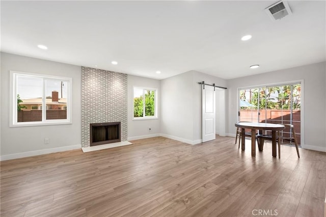 1715 E Redwood Ave, Anaheim, CA 92805 - living area with a barn door, light wood-type flooring, baseboards, a tile fireplace, and recessed lighting