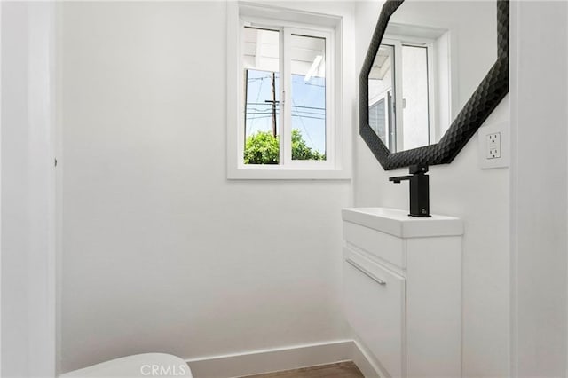 1715 E Redwood Ave, Anaheim, CA 92805 - bathroom featuring toilet, vanity, and baseboards