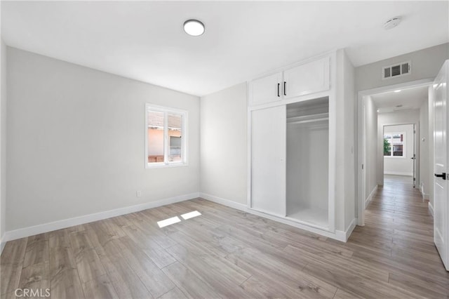 1715 E Redwood Ave, Anaheim, CA 92805 - unfurnished bedroom with light wood-style flooring, baseboards, and a closet