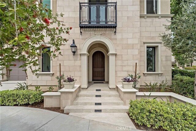 51 Eider Run, Irvine, CA 92618 - doorway to property featuring a balcony and stone siding