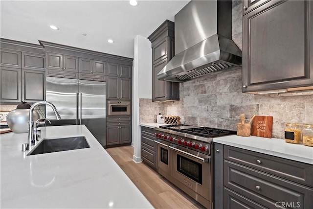 51 Eider Run, Irvine, CA 92618 - kitchen with ventilation hood, high quality appliances, light countertops, decorative backsplash, and recessed lighting