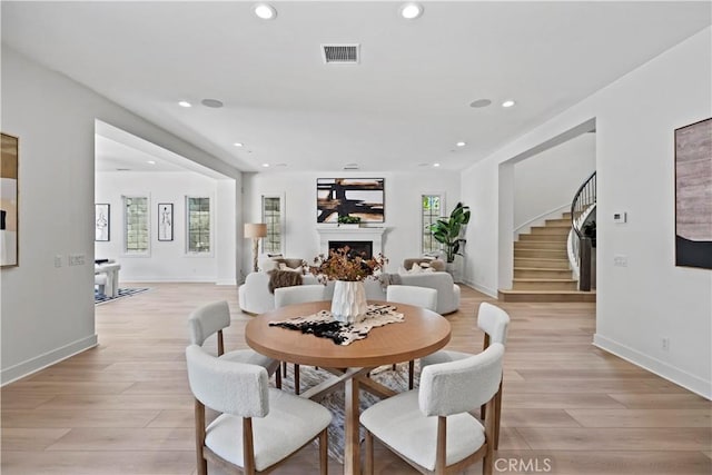 51 Eider Run, Irvine, CA 92618 - dining area with recessed lighting, light wood-style flooring, a fireplace, stairs, and healthy amount of natural light