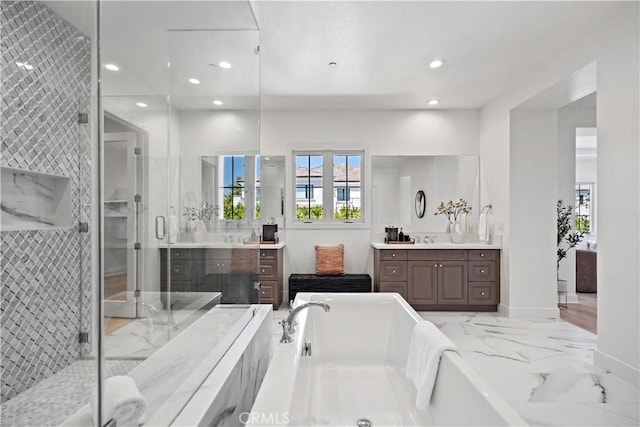 51 Eider Run, Irvine, CA 92618 - full bathroom with two vanities, a freestanding bath, a stall shower, marble finish flooring, and recessed lighting