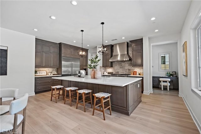 51 Eider Run, Irvine, CA 92618 - kitchen featuring wall chimney range hood, built in fridge, light countertops, recessed lighting, and backsplash