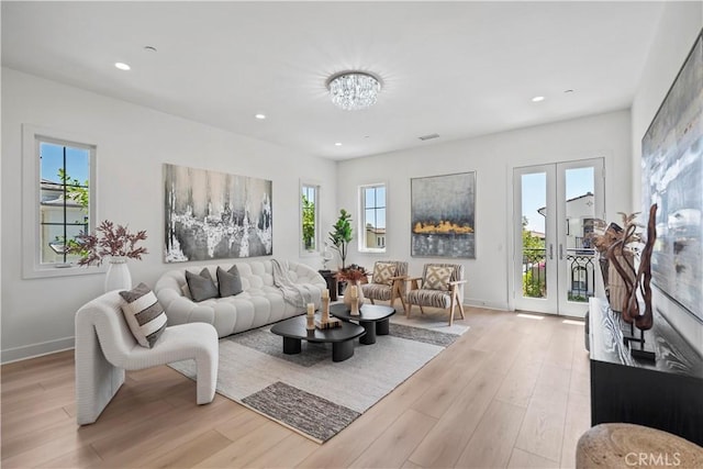 51 Eider Run, Irvine, CA 92618 - living area with light wood-type flooring, french doors, recessed lighting, and a chandelier