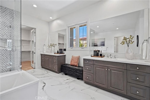 51 Eider Run, Irvine, CA 92618 - full bathroom featuring two vanities, a stall shower, a soaking tub, recessed lighting, and marble finish flooring