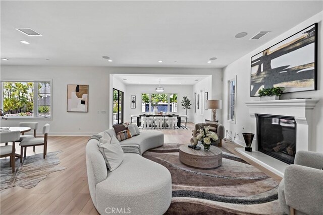 51 Eider Run, Irvine, CA 92618 - living area featuring light wood-style flooring, a glass covered fireplace, and recessed lighting