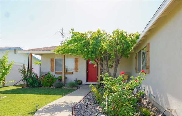 3833 Kennedy St, Le Grand, CA 95333 - view of exterior entry with stucco siding and a yard