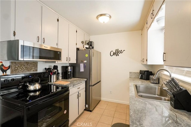 3833 Kennedy St, Le Grand, CA 95333 - kitchen with appliances with stainless steel finishes, a sink, light countertops, light tile patterned flooring, and white cabinets