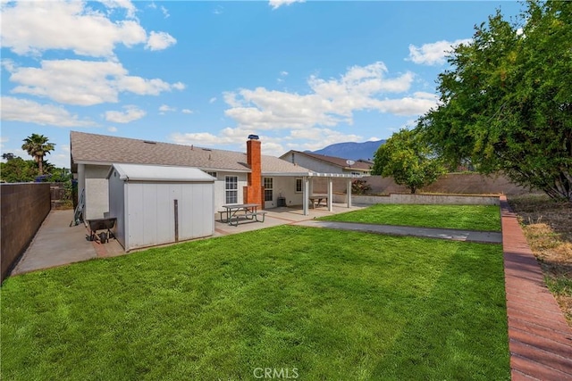 6859 Mango St, Rancho Cucamonga, CA 91701 - rear view of property featuring a patio, a storage shed, a fenced backyard, a chimney, and a mountain view