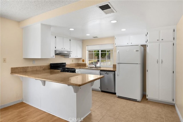 6859 Mango St, Rancho Cucamonga, CA 91701 - kitchen with dishwasher, freestanding refrigerator, range with gas stovetop, under cabinet range hood, and a peninsula