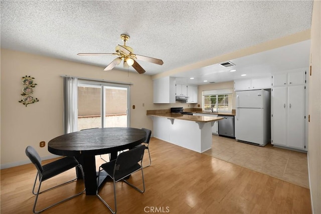 6859 Mango St, Rancho Cucamonga, CA 91701 - dining area featuring a ceiling fan, a textured ceiling, light wood-style flooring, and recessed lighting