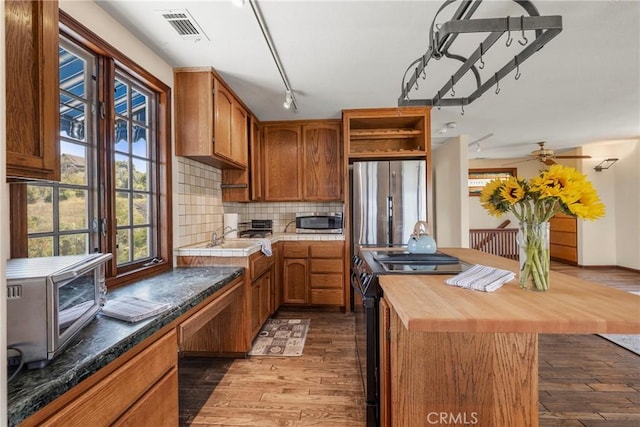 335 Rainbow Crest Rd, Fallbrook, CA 92028 - kitchen with stainless steel appliances, butcher block counters, dark wood-style flooring, open shelves, and backsplash