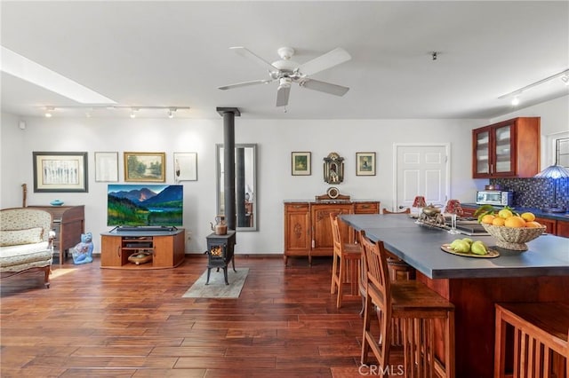 335 Rainbow Crest Rd, Fallbrook, CA 92028 - dining room with rail lighting, a wood stove, a ceiling fan, and dark wood-type flooring