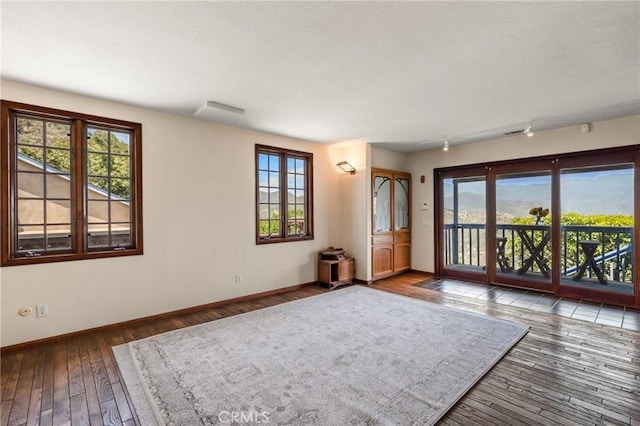 335 Rainbow Crest Rd, Fallbrook, CA 92028 - spare room with baseboards, wood-type flooring, and track lighting