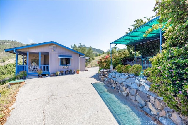335 Rainbow Crest Rd, Fallbrook, CA 92028 - back of property with a porch, a mountain view, and asphalt driveway