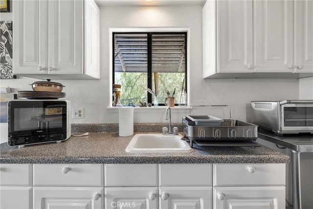 335 Rainbow Crest Rd, Fallbrook, CA 92028 - kitchen featuring a sink, white cabinets, and dark countertops