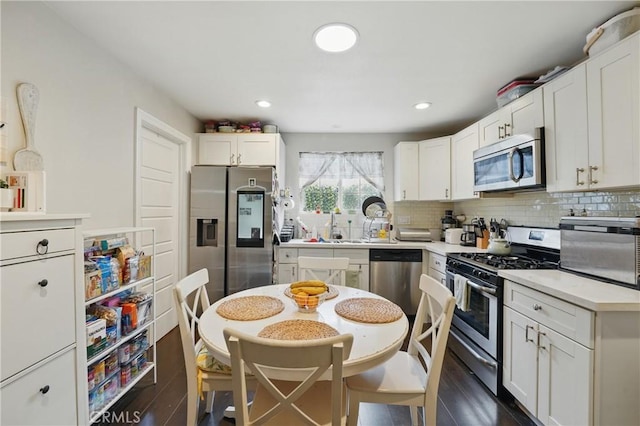 4819 Church St, Pico Rivera, CA 90660 - kitchen featuring stainless steel appliances, backsplash, white cabinetry, and recessed lighting