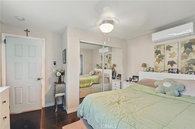 4819 Church St, Pico Rivera, CA 90660 - bedroom featuring an AC wall unit, a closet, dark wood-type flooring, baseboards, and a ceiling fan