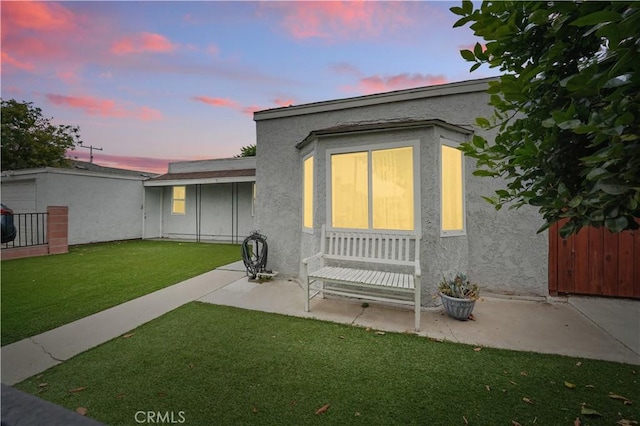 4819 Church St, Pico Rivera, CA 90660 - back of property at dusk with a patio and stucco siding