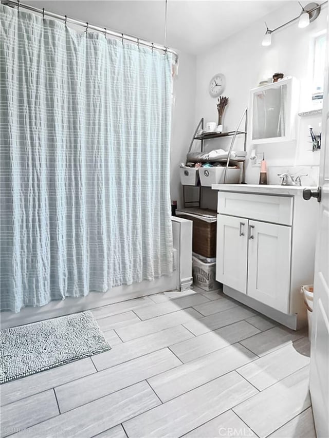 4819 Church St, Pico Rivera, CA 90660 - bathroom with wood finish floors, vanity, and shower / bath combination with curtain