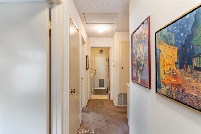 26181 Goldenwood St, Menifee, CA 92586 - corridor with carpet, a textured ceiling, and attic access
