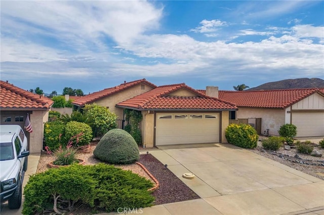 26181 Goldenwood St, Menifee, CA 92586 - mediterranean / spanish-style house featuring a garage, stucco siding, concrete driveway, and a tiled roof