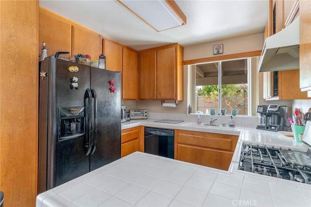 26181 Goldenwood St, Menifee, CA 92586 - kitchen featuring black appliances, under cabinet range hood, tile counters, a sink, and brown cabinets