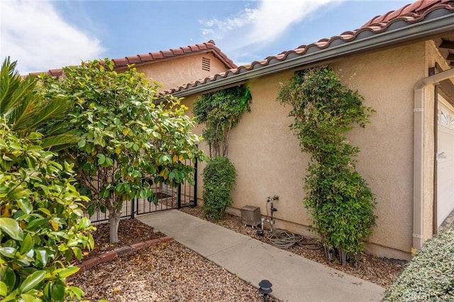 26181 Goldenwood St, Menifee, CA 92586 - entrance to property with a gate, stucco siding, and a tiled roof