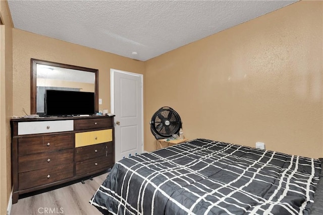 11225 1st St, Hesperia, CA 92345 - bedroom with light wood-style floors and a textured ceiling