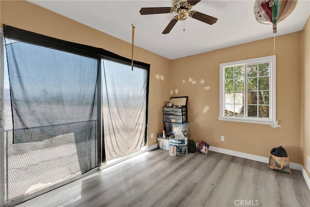 11225 1st St, Hesperia, CA 92345 - spare room featuring wood finished floors, a ceiling fan, and baseboards