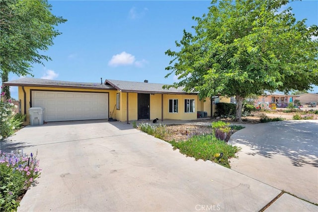 11225 1st St, Hesperia, CA 92345 - view of front of property with a garage, driveway, and stucco siding