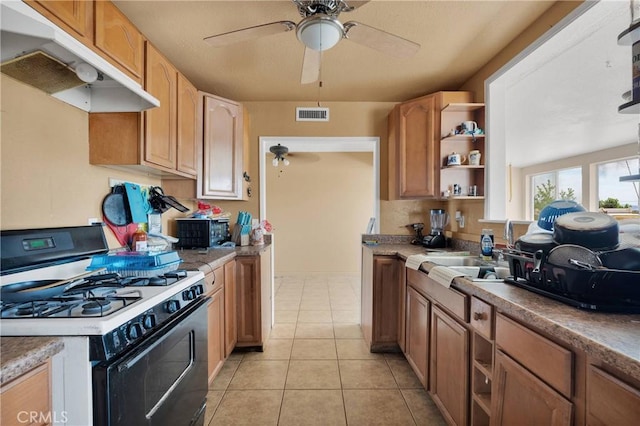 11225 1st St, Hesperia, CA 92345 - kitchen with range with gas stovetop, under cabinet range hood, ceiling fan, open shelves, and light tile patterned flooring