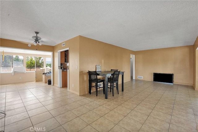 11225 1st St, Hesperia, CA 92345 - dining area featuring a textured ceiling, light tile patterned floors, a ceiling fan, and baseboards