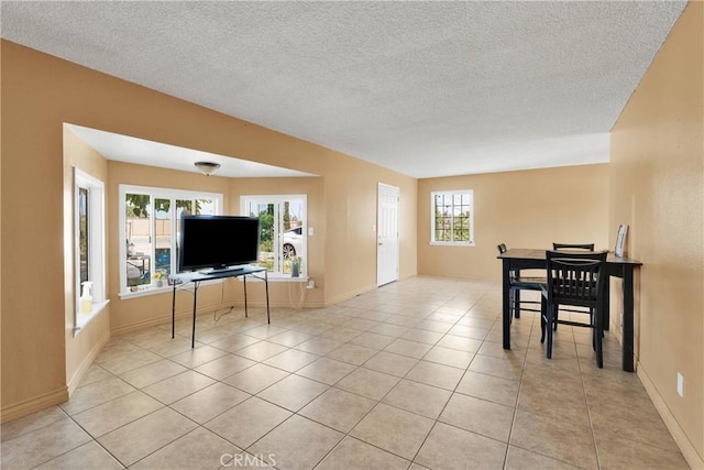11225 1st St, Hesperia, CA 92345 - living area featuring a textured ceiling, light tile patterned floors, and baseboards