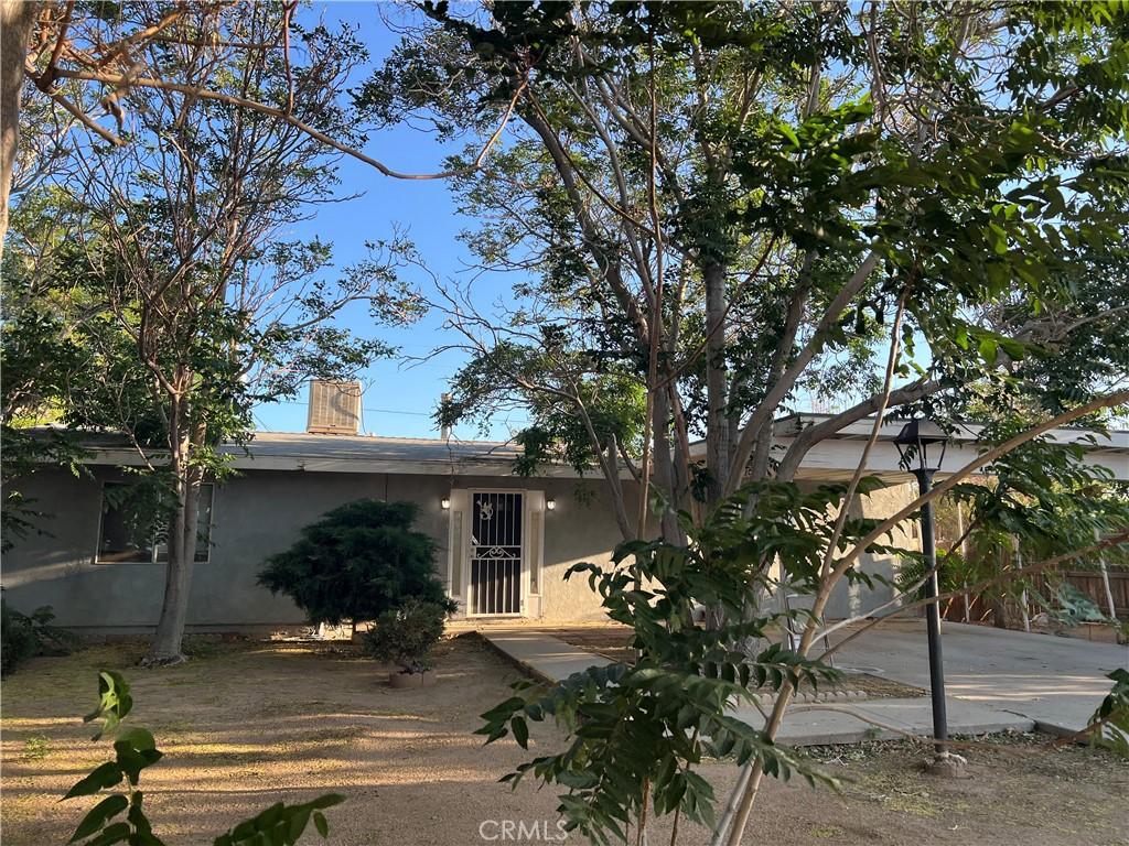 16275 Cajon St, Hesperia, CA 92345 - rear view of house featuring stucco siding and a chimney