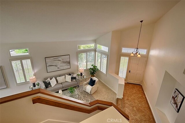 24650 Via Melinda, Yorba Linda, CA 92887 - carpeted living area with baseboards, lofted ceiling, and a chandelier