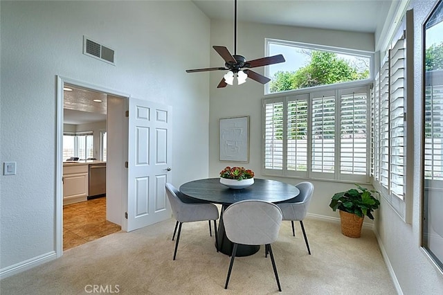 24650 Via Melinda, Yorba Linda, CA 92887 - dining space featuring light colored carpet, a ceiling fan, baseboards, a towering ceiling, and a textured wall