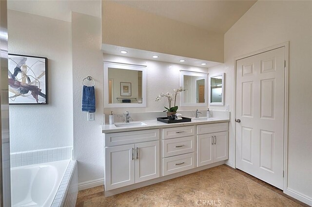 24650 Via Melinda, Yorba Linda, CA 92887 - bathroom featuring double vanity, tiled tub, baseboards, and tile patterned floors