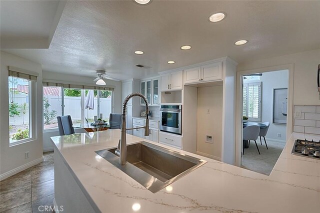 24650 Via Melinda, Yorba Linda, CA 92887 - kitchen featuring appliances with stainless steel finishes, a sink, baseboards, recessed lighting, and light stone counters
