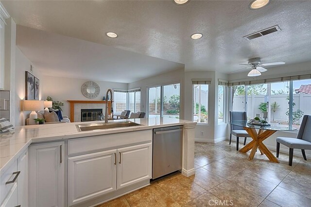 24650 Via Melinda, Yorba Linda, CA 92887 - kitchen with stainless steel dishwasher, a sink, open floor plan, a tiled fireplace, and light countertops